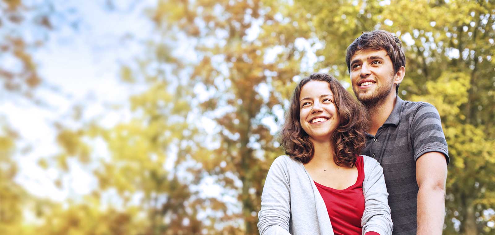 Couple walking in the woods smiling