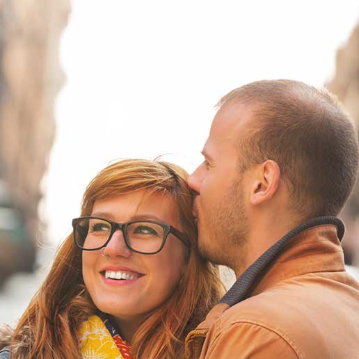 Man kissing woman's hair