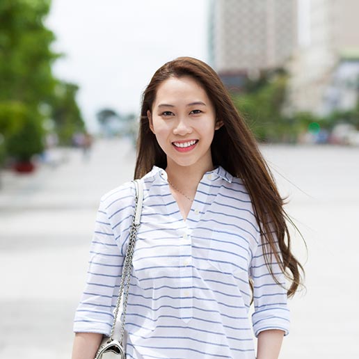 Smiling young woman in white shirt