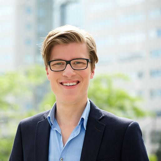 Man with blue jacket and glasses